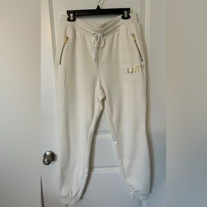 Guess White Joggers with gold lettering and zippers